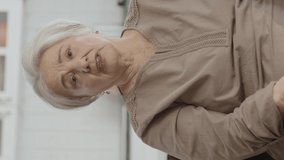 Sad old woman health problems.Elderly woman suffering from panic attack or memory loss concept with strong headache.Video for the vertical story.