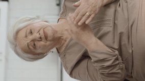 The old woman is very upset by the news she has received.Lonely old woman sitting alone on sofa at home. Portrait of unhappy old woman.Video for the vertical story. - Powered by Shutterstock - Get 15% off with code: PIKWIZARD15