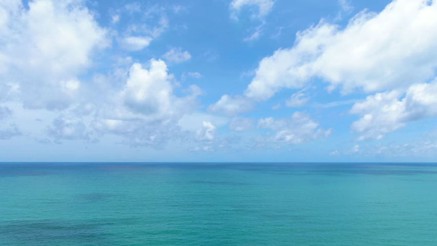 Blue sky clouds over ocean. Scenic sea waves aerial view wide drone over ocean sunny day summer United States. Beautiful panorama white clouds good video B roll, insert,Slow motion,Cinematic.  Royalty-Free Stock Footage #1090897775