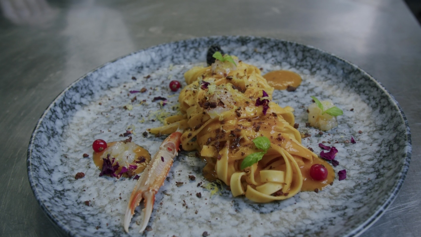 Close up shot of a plate full of pasta and scampi made from a professional chef in Italy - 01