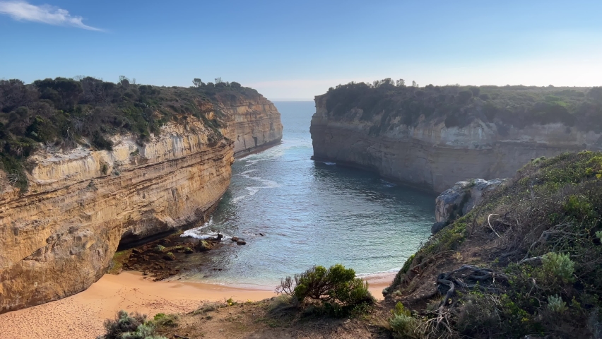 Large rock formations at The Twelve Apostles with water in gorge and beach
