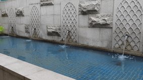 Modern concrete water fountain with beautiful space. A concrete water fountain on a sunny day. water fountain static shot closeup view. 4K video.