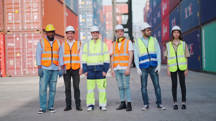 Group of engineer worker finish work and walking back home from the shipping yard container. Take off safety helmet. Import, export product. Manufacturing transport and global business concept