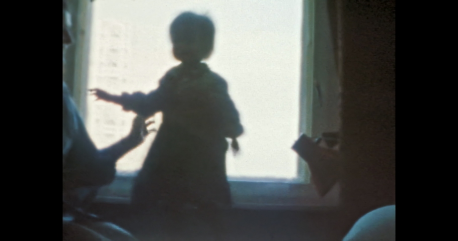 Happy mother having fun with laughing child in room. Cheerful young woman hugging Smiling baby girl near window home. Fanny family life indoors. Vintage color film. Family archive. Retro 1980s. 4k | Shutterstock HD Video #1090901521
