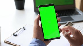 4k video footage of green screen for copy space Chroma key mock-up on a smartphone in hand. Closeup of hand using a smartphone digital banking, E-commerce concept.