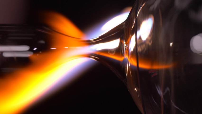 scientist engineer chemist with a gas burner melts glass and delvet from it plasma balls and lamps with current Royalty-Free Stock Footage #1090903159