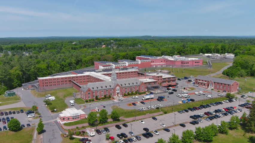 Aerial establishing shot of prison in America. Rising above to show wide shot of whole complex. Royalty-Free Stock Footage #1090906865