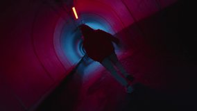 Camera roll of parkour athlete running through dark underground tunnel with neon light and performing side flip - Powered by Shutterstock - Get 15% off with code: PIKWIZARD15