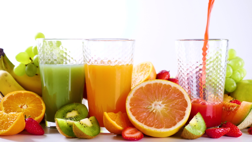 pour fresh fruit juice into glasses