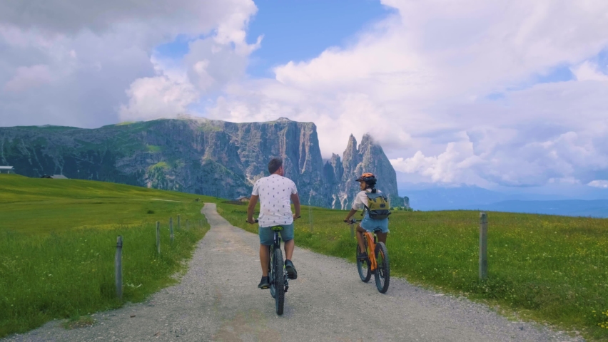 couple men and woman on vacation in the Dolomites Italy, Alpe di Siusi - Seiser Alm South Tyrol, Italy. Europe