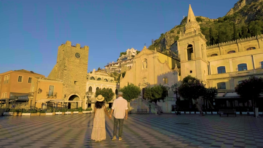 Taormina Sicily, Belvedere of Taormina and San Giuseppe church on the square Piazza IX Aprile in Taormina. Sicily, Italy. Couple on vacation at the Italian Island Sicily