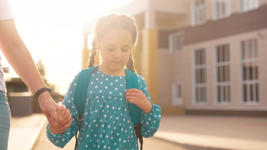 back to school. mom and daughter a go hand in hand to school for lesson. education training support concept. child walk to school with a backpack. daughter mom rush to school lifestyle. family day Royalty-Free Stock Footage #1090920527