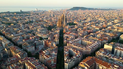 Aerial view of Barcelona Eixample residential district and famous Basilica Sagrada Familia at sunrise. Catalonia, Spain – Stockvideo