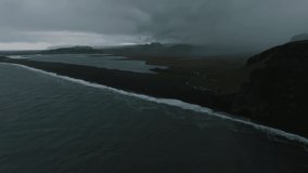 Iceland black sand beach with huge waves at Reynisfjara Vik. Aerial cinematic 4k video. Beautiful Iceland nature coastline from above.