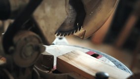 Time-lapse video of a carpenter in a workshop working with a circular saw, sawing a wooden board in close-up. Joinery, manufacturers of furniture parts. Wooden products. Carpentry tools