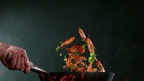 Super slow motion of flying whole prawns from wok pan. Filmed on high speed cinema camera, 1000 fps. Speed ramp effect. - Powered by Shutterstock - Get 15% off with code: PIKWIZARD15
