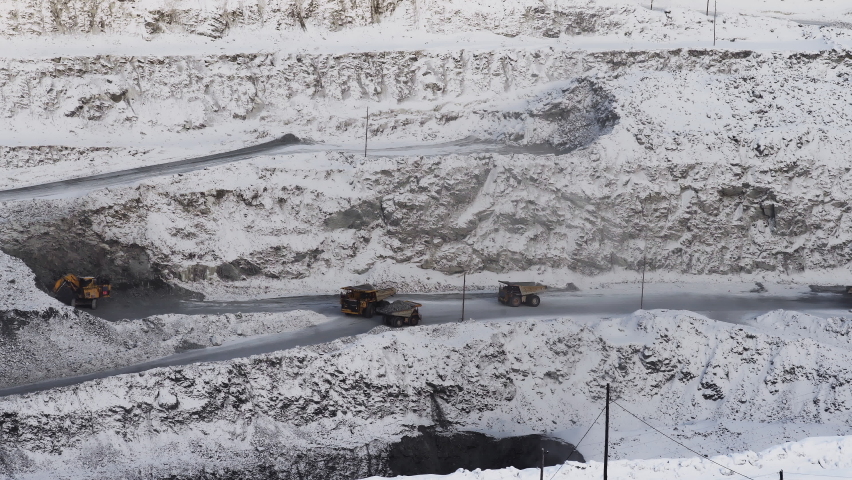 Open pit mine coal mining, dumpers, quarrying extractive industry stripping work. Big Mining Trucks. View from drone at opencast mining with lots of machinery trucks | Shutterstock HD Video #1090943079
