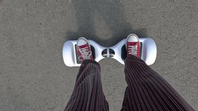 Young person riding hoverboard or electric self balancing scooter 4k. First person view POV - Powered by Shutterstock - Get 15% off with code: PIKWIZARD15