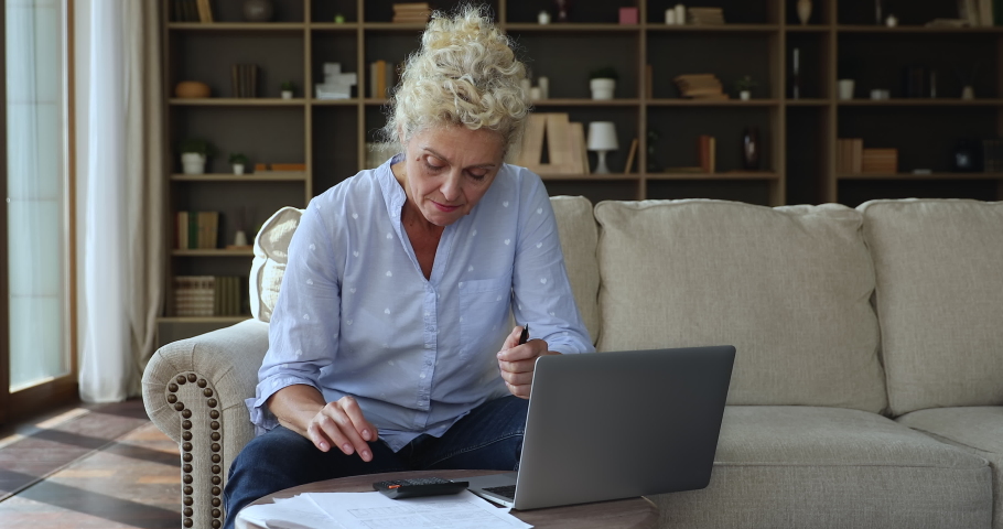 Middle-aged woman calculates monthly expenses feels nervous, having money lack, financial problems, small pension, mistake in report looks annoyed and stressed. Bankruptcy, financial crisis concept Royalty-Free Stock Footage #1090949439