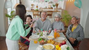 birthday party at senior daycare,group of asian female elder male female laugh smile positive conversation greeting in birthday friend party at nursing home senior group video call to family in party
