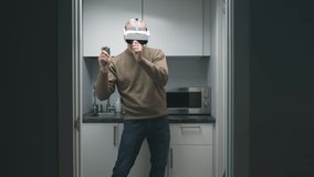 Happy aged man in augmented reality headset dancing in small kitchen.  - Powered by Shutterstock - Get 15% off with code: PIKWIZARD15