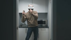 Happy aged man in augmented reality headset dancing in small kitchen. 