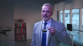 Portrait of mature businessman drink coffee and work on virtual screen. Copy space for CG graphics. Senior entrepreneur read information and scroll screen projection - Powered by Shutterstock - Get 15% off with code: PIKWIZARD15