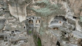 A camera drone flies out of Vardzia cave city and monastery, Georgia