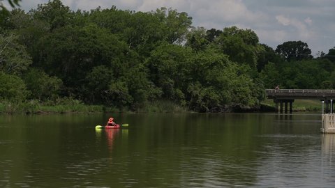 Pasadena, TX, US - June 05, 2022: Kayaker drifts up Armand Bayou in Pasadena Texas