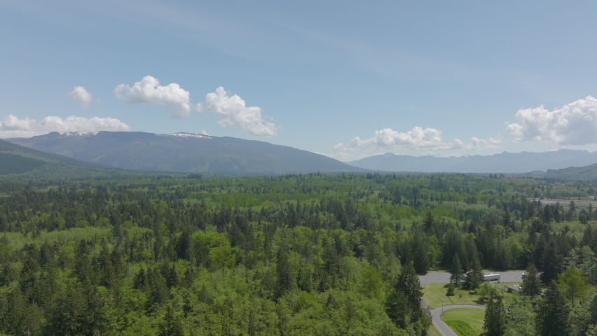 Gorgeous panoramic view of Bellingham, Washington on a sunny day with the highway going through and mountains and foothills on the horizon.