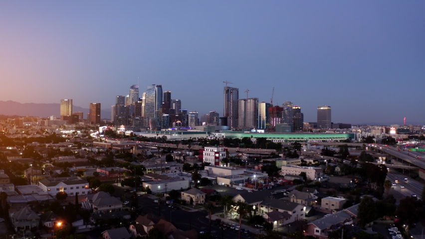 Aerial establishing shot of Los Angeles. Dark sky as traffic flows on highway. Downtown Los Angeles aerial view, business centre Cinematic aerial drone footage of downtown urban LA.  Drone. 4K. 