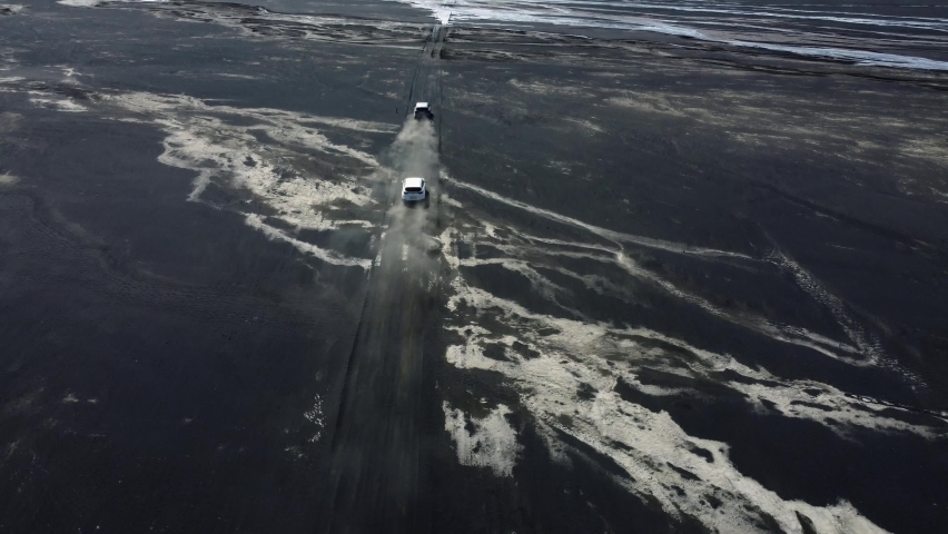 Cars ride on balck desert in Iceland. Aerial drone video of Icelandic landscape. Famous tourist attractions and landmarks destinations in Icelandic nature on Iceland. 4K UHD video.	

