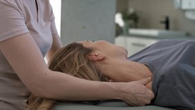 Close up female physical therapist massaging her patient. Shot with RED helium camera in 8K.  