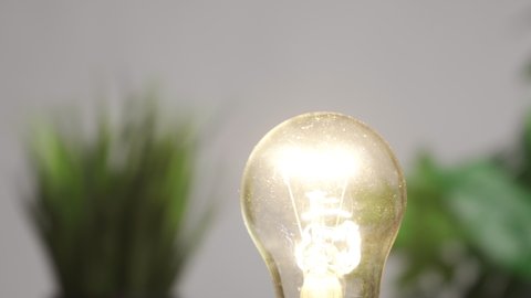 Replacing an outdated incandescent bulb with a new LED energy-saving bulb