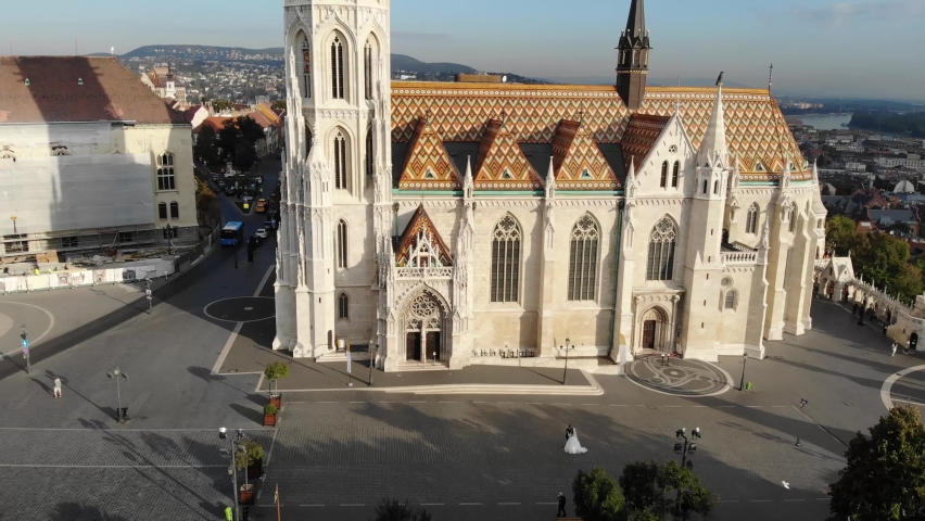 Couple of brides on the background of the church in Budapest, Hungary