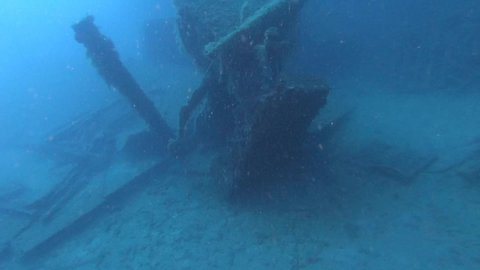 Scuba divers swims on the Shipwreck Swedish ferry MS Zenobia. Wreck diving. Mediterranean sea, Cyprus. Maritime disasters. Underwater 4K video filming Shot Of Sunken Ship. World tragedies under water.