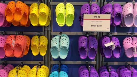Springfield, IL USA - May 2, 2022: Zooming out on rows of Crocs shoes at the Scheels Sporting Goods store in Springfield, Illinois.