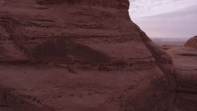 Rock formation canyon in Saudi Arabia during sunrise, sunset. Drone, aerial footage video. Over rocks, canyons, desert, sand. Al Ula, UNESCO world heritage site and a main tourist attraction.