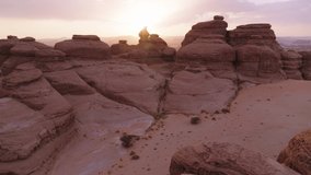 Rock formation canyon in Saudi Arabia during sunrise, sunset. Drone, aerial footage video. Over rocks, canyons, desert, sand. Al Ula, UNESCO world heritage site and a main tourist attraction.
