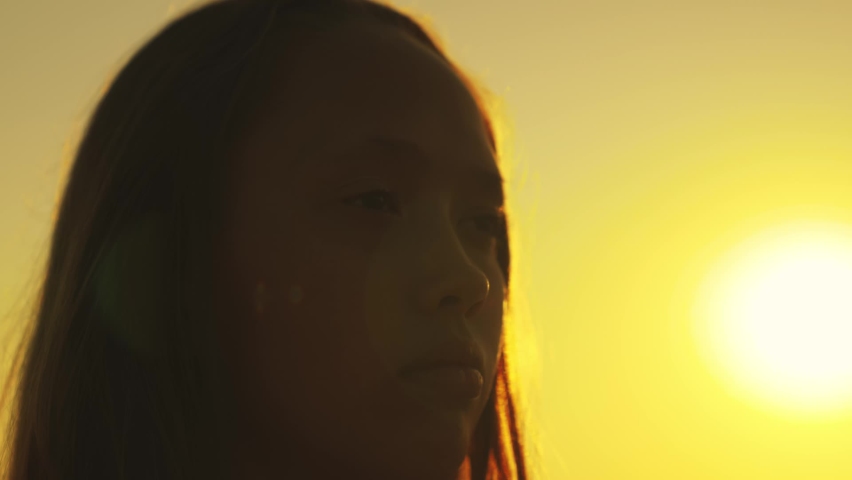 concept children's dream. girl daughter praying sunset dreaming good future. child face look sky closing his eyes. silhouette child girl sun. happy family. religious education person. childhood dream Royalty-Free Stock Footage #1090975173