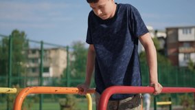 a teenage boy trains on a sports ground outdoors, he does physical exercises, a healthy lifestyle, a bright sunny day in summer - Powered by Shutterstock - Get 15% off with code: PIKWIZARD15