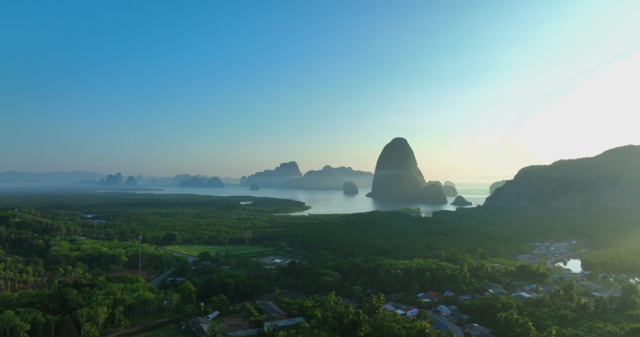 Aerial view of Phang Nga bay national park in Krabi, Thailand. Stunning tropical landscape show line of water with mangroves forest along the sides and clear blue sky. Drone shot over the Bay. | Shutterstock HD Video #1090979003