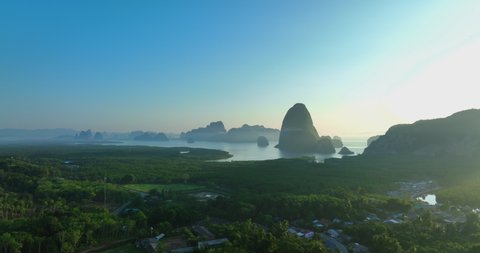 Aerial view of Phang Nga bay national park in Krabi, Thailand. Stunning tropical landscape show line of water with mangroves forest along the sides and clear blue sky. Drone shot over the Bay.