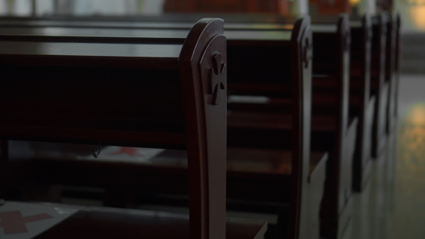 Empty seats in a Catholic church without people in a dark room | Shutterstock HD Video #1090979833