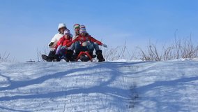 Happy parents and their children riding on sleds in winter