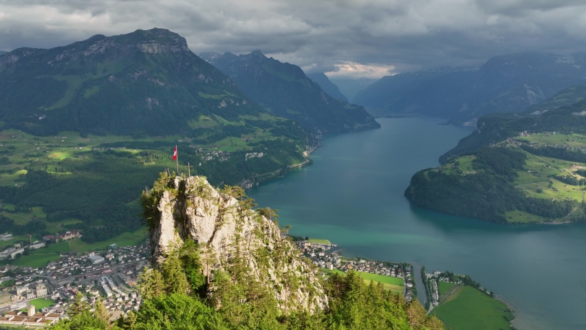 Lake Lucerne aerial view, epic beautiful view of mountain lake in Switzerland with Swiss flag on a rock, panoramic view of Luzern lake, amazing Swiss alpine landscape  Royalty-Free Stock Footage #1090989095