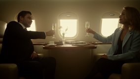 Business partners shaking hands celebrating successful deal jet fly. Smiling elegant businesswoman handshaking talking confident executive relax corporate flight. People passengers drink champagne - Powered by Shutterstock - Get 15% off with code: PIKWIZARD15