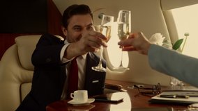 Business people shaking hands on private jet closeup. Corporate team celebrating success drinking champagne. Smiling businessman making deal with unknown partner at porthole. Achievement concept. - Powered by Shutterstock - Get 15% off with code: PIKWIZARD15