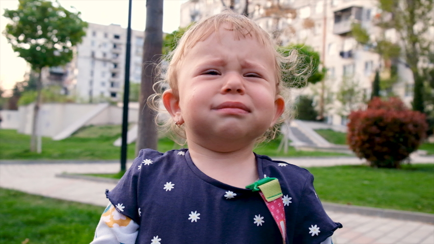 Baby crying in the park. Selective focus.