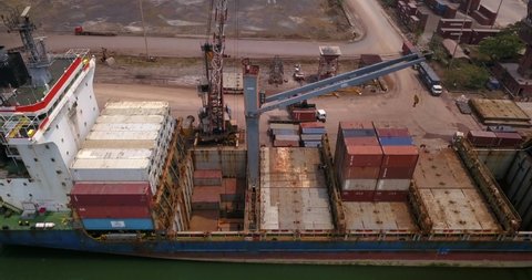 Top View Of A Loaded Cargo Ship With Intermodal Containers Docked At Mangalore Port In India. Aerial Shot